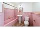 Retro pink bathroom features original tile work, vintage fixtures, and charming details at 425 49Th N St, St Petersburg, FL 33710