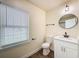 Well-lit bathroom with a window, modern vanity, toilet, and a towel bar, creating a comfortable and functional space at 425 49Th N St, St Petersburg, FL 33710