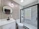 Bathroom featuring tile flooring, a glass-enclosed shower with block glass, and modern fixtures at 425 49Th N St, St Petersburg, FL 33710