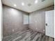 Bedroom featuring gray wood-look tile flooring, tiled accent wall, and window at 425 49Th N St, St Petersburg, FL 33710