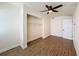 Bedroom featuring wood-look flooring, a closet with wire shelving, a ceiling fan, and a white door at 425 49Th N St, St Petersburg, FL 33710
