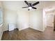 Cozy bedroom features wood-look floors, a mini-refrigerator, closet, and a modern ceiling fan for added comfort at 425 49Th N St, St Petersburg, FL 33710