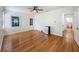 Bedroom with hardwood floors, a ceiling fan, mini fridge and access to an updated bathroom at 425 49Th N St, St Petersburg, FL 33710