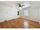 Bright bedroom featuring hardwood floors, multiple closets, a ceiling fan, and natural light at 425 49Th N St, St Petersburg, FL 33710