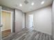 Bedroom featuring wood-look tile flooring, tiled accent wall, and doors to a bathroom and closet at 425 49Th N St, St Petersburg, FL 33710