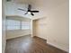 Bedroom featuring wood-look flooring, a ceiling fan, closet, and window with blinds at 425 49Th N St, St Petersburg, FL 33710