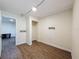 Room has wood-look floors, neutral walls and trim, a small storage shelf and access to a closet at 425 49Th N St, St Petersburg, FL 33710