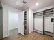 Closet featuring wood-look flooring, custom shelving, and an open door to a hallway at 425 49Th N St, St Petersburg, FL 33710