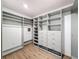 Custom closet featuring built-in shelving, drawers, and wood-look flooring at 425 49Th N St, St Petersburg, FL 33710