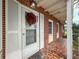Charming brick front porch with mosaic tile, festive wreath, and classic architectural details at 425 49Th N St, St Petersburg, FL 33710