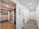 Hallway featuring wood-look flooring, a closet, and doors to another closet and a bathroom with tiled shower at 425 49Th N St, St Petersburg, FL 33710