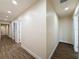 Long hallway featuring wood-look floors, recessed lighting, and doors leading to various rooms at 425 49Th N St, St Petersburg, FL 33710