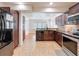 Open kitchen features stainless steel appliances, granite countertops, and a stone backsplash at 425 49Th N St, St Petersburg, FL 33710