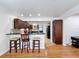 Eat-in kitchen features a breakfast bar with seating and hardwood floors in the living room at 425 49Th N St, St Petersburg, FL 33710