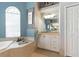 Bathroom with soaking tub, vanity and storage, with framed seahorse art at 4428 Gevalia Dr, Brooksville, FL 34604