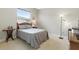 Neutral bedroom with Queen bed, matching linens, a window, and a minimalist design at 4428 Gevalia Dr, Brooksville, FL 34604