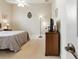 Bedroom with carpeting, dresser, table lamp, and a bed at 4428 Gevalia Dr, Brooksville, FL 34604