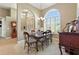 Spacious dining room features a decorative chandelier, six-chair table, and arched windows at 4428 Gevalia Dr, Brooksville, FL 34604