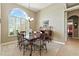 Dining room boasts a decorative chandelier, six-chair table set, and large window at 4428 Gevalia Dr, Brooksville, FL 34604
