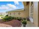 Close-up view of side entrance with lush landscaping, potted plants, and a cozy seating area at 4428 Gevalia Dr, Brooksville, FL 34604