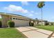 Spacious single-story home featuring an attached two-car garage and meticulously maintained landscaping at 4428 Gevalia Dr, Brooksville, FL 34604