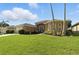 Charming single-story home with arched windows, lush landscaping, and a spacious driveway at 4428 Gevalia Dr, Brooksville, FL 34604