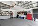 Spacious garage with abundant storage shelves, tool chests and overhead lighting at 4428 Gevalia Dr, Brooksville, FL 34604