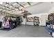 Spacious garage featuring ample storage, a golf cart and an organized workspace at 4428 Gevalia Dr, Brooksville, FL 34604