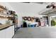 Spacious garage featuring an organized storage system with shelves, cabinets, and plenty of open space at 4428 Gevalia Dr, Brooksville, FL 34604