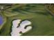 Scenic aerial view of a lush green golf course with sand traps and water features at 4428 Gevalia Dr, Brooksville, FL 34604