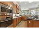 Modern kitchen featuring granite countertops, custom cabinets, and stainless steel appliances at 4428 Gevalia Dr, Brooksville, FL 34604