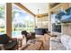 View of a spacious lanai with comfortable seating, hot tub and an outdoor television at 4428 Gevalia Dr, Brooksville, FL 34604