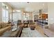 Open concept living room featuring tile floors, large windows, and comfortable seating at 4428 Gevalia Dr, Brooksville, FL 34604