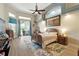 Main bedroom features hardwood floors, ceiling fan, and large sliding glass door at 4428 Gevalia Dr, Brooksville, FL 34604