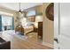 Light-filled main bedroom features hardwood floors, ceiling fan, and large arched window at 4428 Gevalia Dr, Brooksville, FL 34604