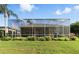 Beautiful screened-in pool, surrounded by lush landscaping, offers privacy and relaxation at 4428 Gevalia Dr, Brooksville, FL 34604