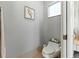 Powder room features toilet with shelf, and framed seahorse art at 4428 Gevalia Dr, Brooksville, FL 34604