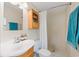Bathroom featuring vanity, toilet, shower, and linen storage at 4915 Stolls Ave, Tampa, FL 33615