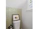 Charming half bathroom with textured accent wall, a toilet, and natural light at 4915 Stolls Ave, Tampa, FL 33615