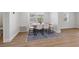 Dining room with modern table, chairs, and area rug over hardwood floors at 4915 Stolls Ave, Tampa, FL 33615