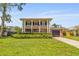 Two-story home featuring a lovely lawn, brick accents, and an attached garage and rooftop patio at 4915 Stolls Ave, Tampa, FL 33615