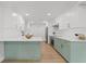 Bright kitchen boasts white cabinets, modern countertops, an island, and stainless steel appliances at 4915 Stolls Ave, Tampa, FL 33615