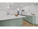 Spacious kitchen features white cabinets, an island with seating, stainless steel appliances, and ample counter space at 4915 Stolls Ave, Tampa, FL 33615