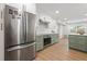 Spacious kitchen featuring an island, stainless steel appliances, and modern cabinets at 4915 Stolls Ave, Tampa, FL 33615