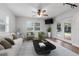 Cozy living room featuring a plush sofa, modern décor, and sliding glass doors to pool at 4915 Stolls Ave, Tampa, FL 33615