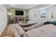 Comfortable living room featuring modern decor, a large screen TV, and ample natural light at 4915 Stolls Ave, Tampa, FL 33615