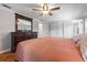 Large main bedroom featuring hardwood floors, natural light, and a ceiling fan at 4915 Stolls Ave, Tampa, FL 33615