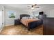 Main bedroom with hardwood floors, lots of natural light, ceiling fan and ensuite bathroom at 4915 Stolls Ave, Tampa, FL 33615