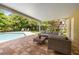 Inviting patio with comfortable seating beside a sparkling pool and lush tropical landscaping at 4915 Stolls Ave, Tampa, FL 33615