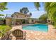 Relaxing backyard pool, complete with patio and lush greenery, creating an ideal tropical oasis at 4915 Stolls Ave, Tampa, FL 33615